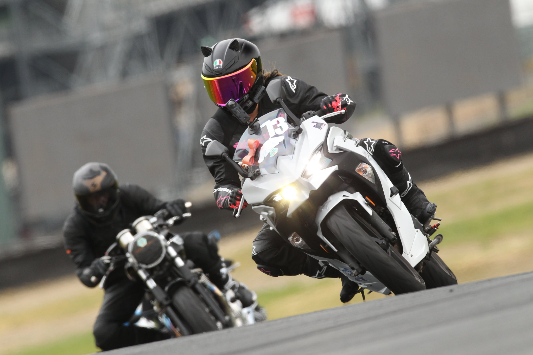 A sportbike rider leaned through a closed-course track corner.